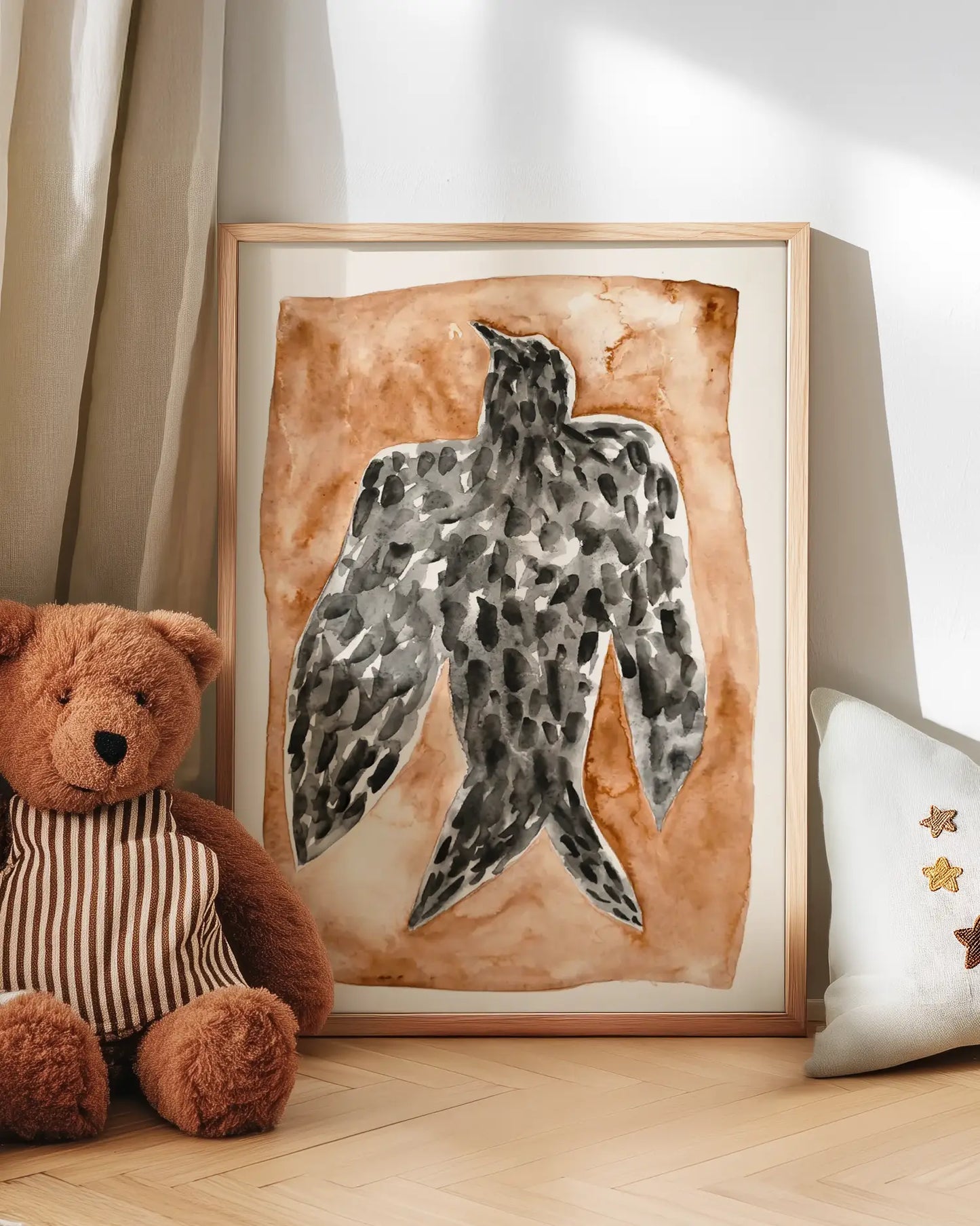 Framed artwork of a falcon bird on a brown background next to a teddy bear and decorative pillow.
