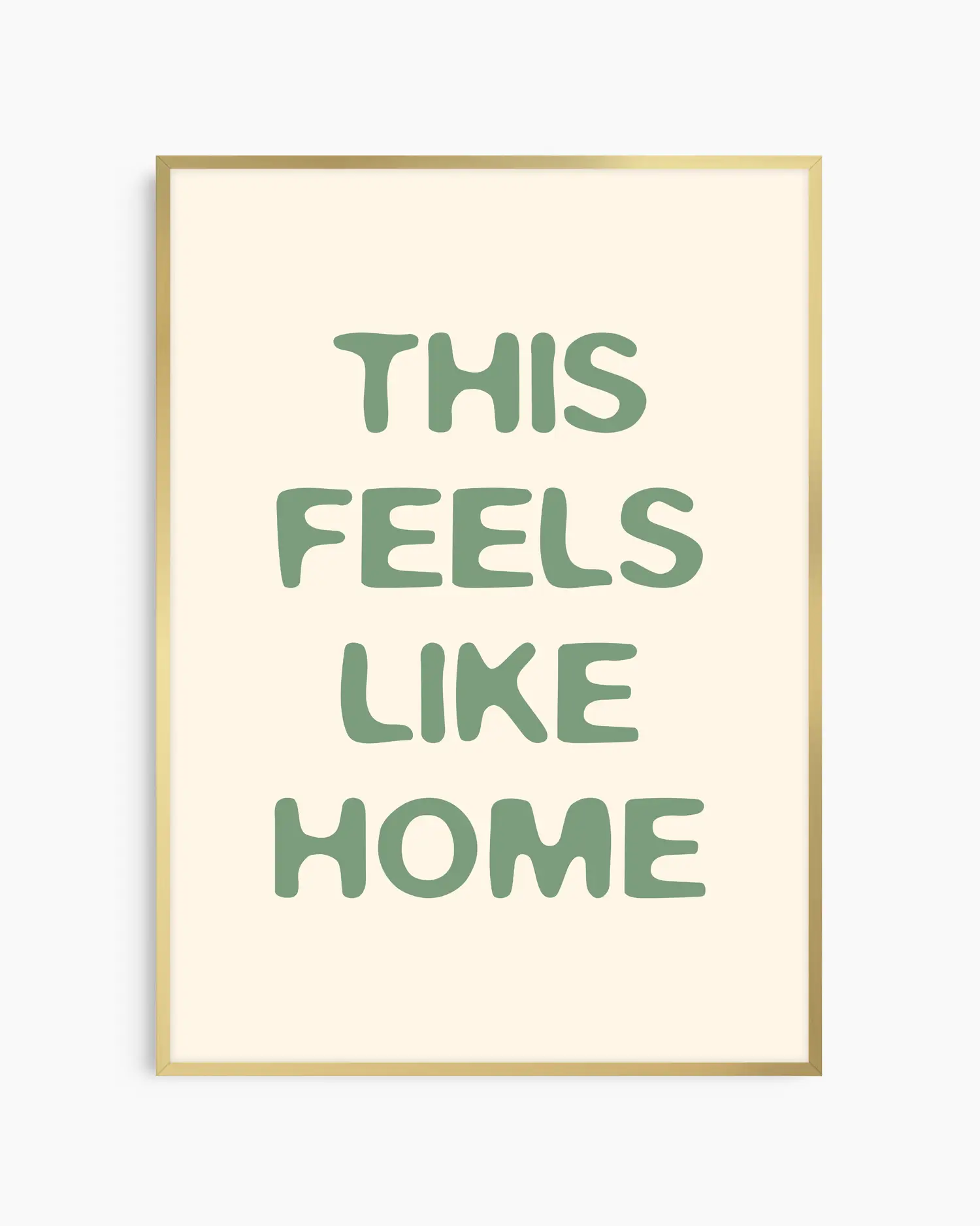Nursery poster with the text 'This feels like home' written in green, inserted in an gold frame