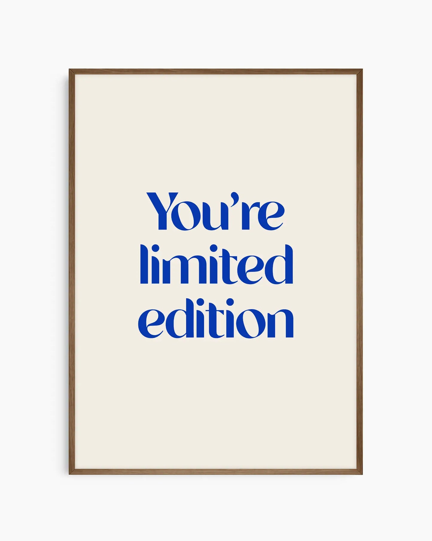 Nursery poster with 'You're limited edition' text in blue framed in a dark oak frame