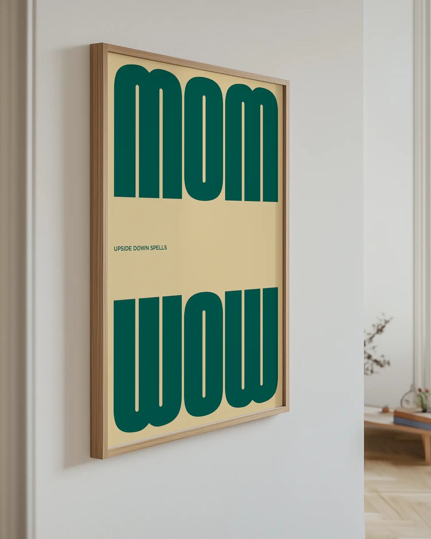 Artwork with 'MOM upside down spells WOW' in green text hanging on the wall.