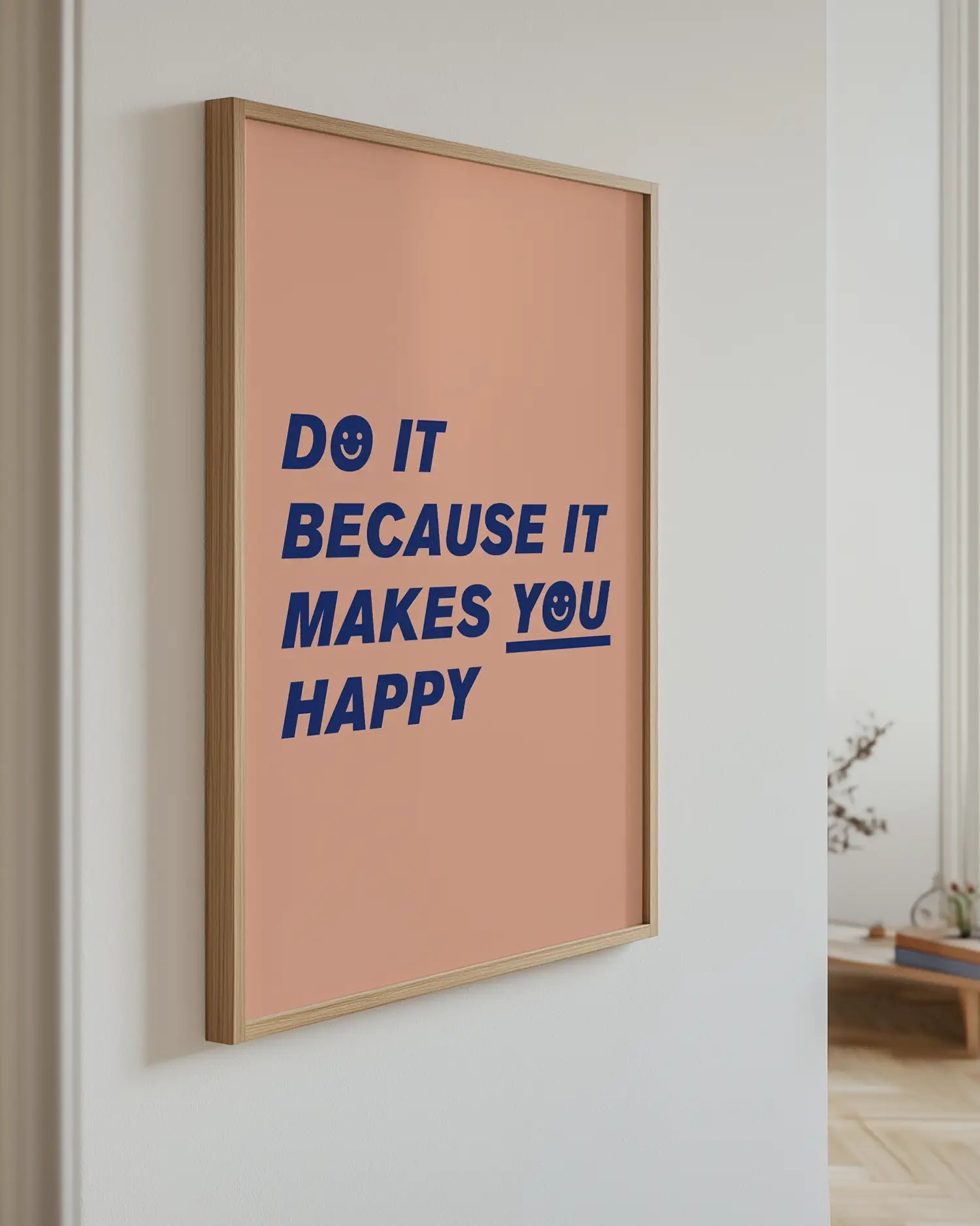 Framed poster with motivational quote on a wall