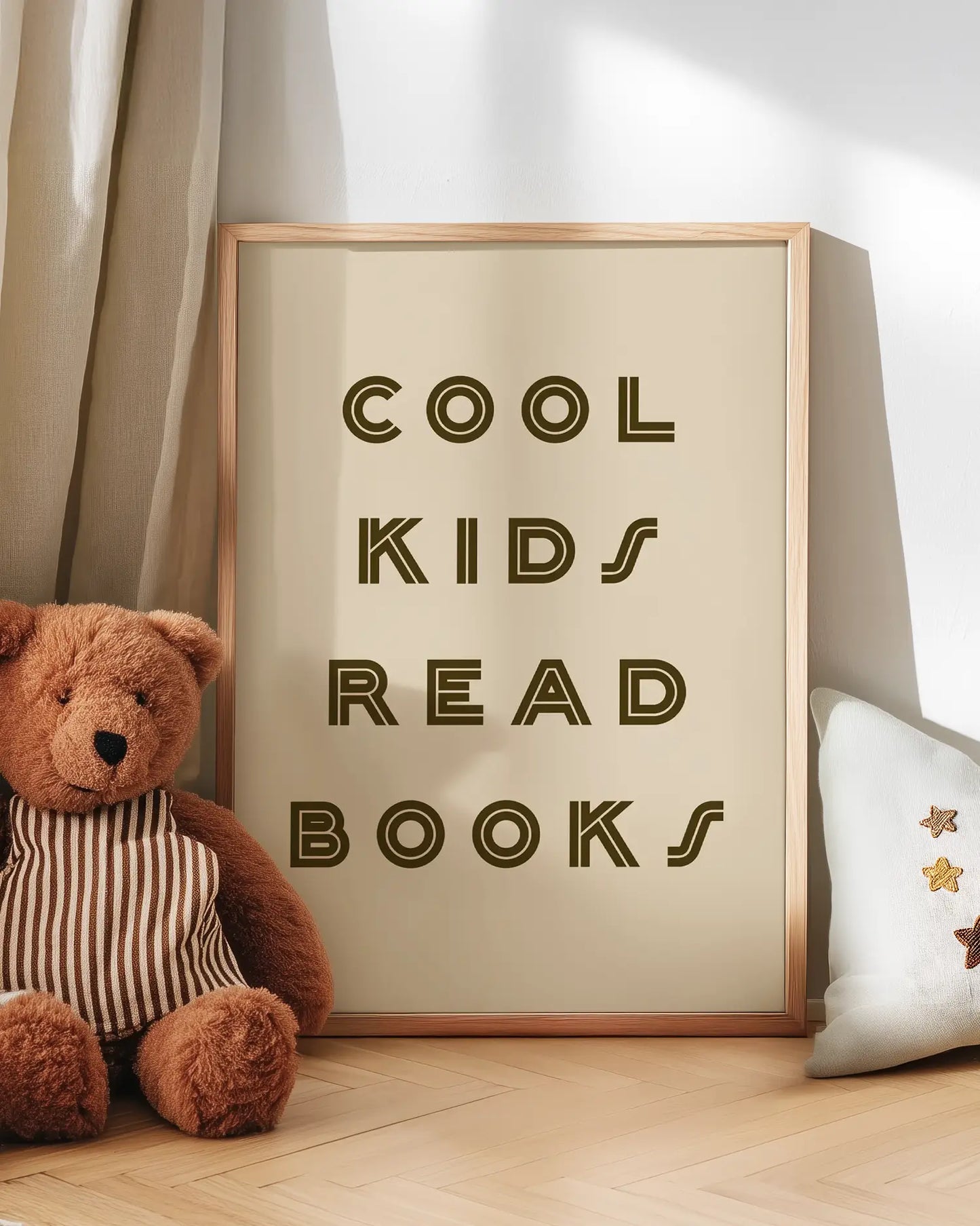 Poster with 'Cool kids read books' text next to a teddy bear on a wooden floor.