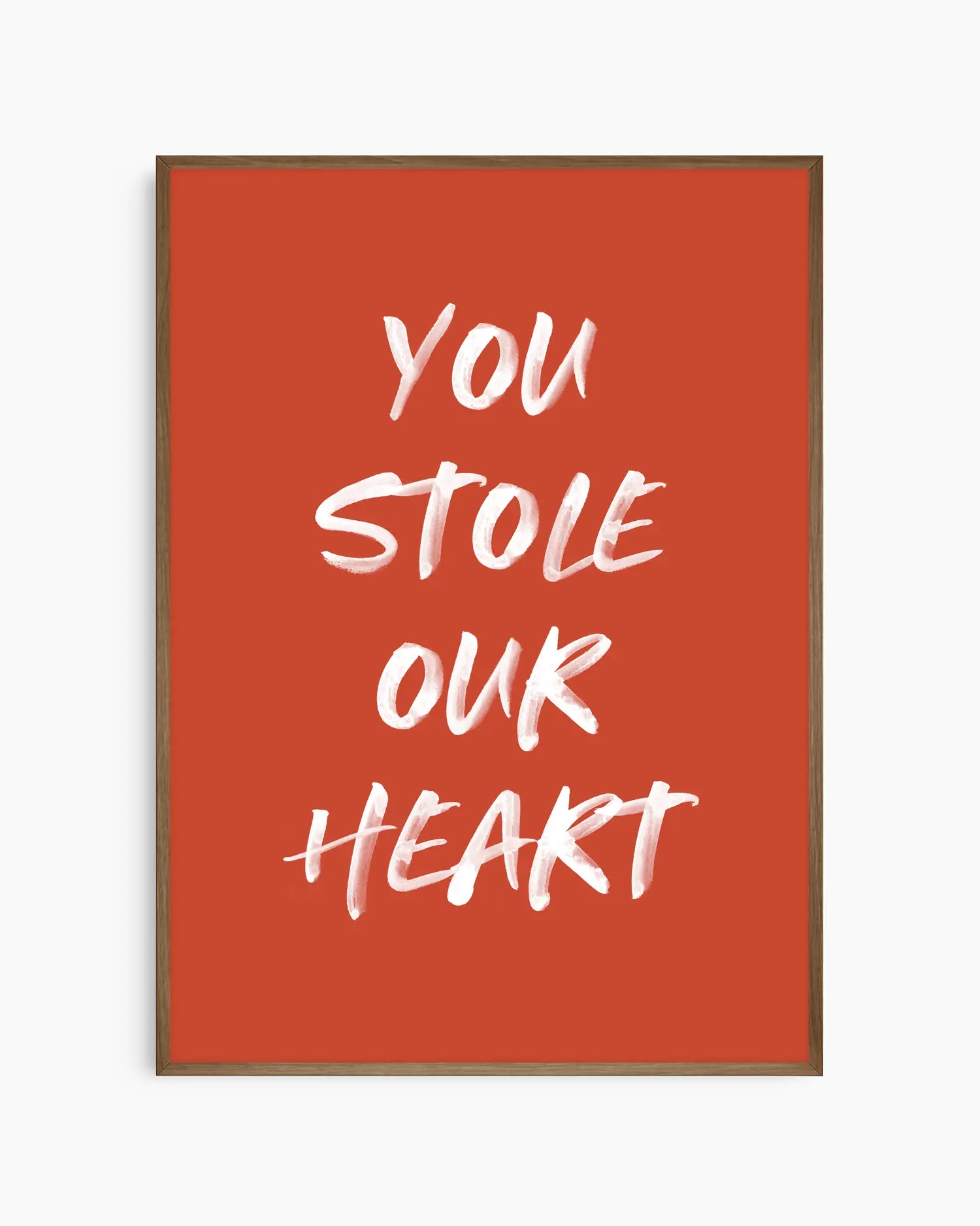 Nursery poster with white text 'You stole our heart' on a red background. Dark oak frame.