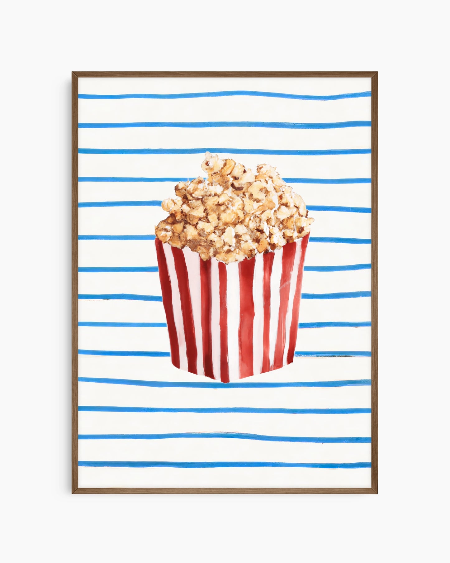 Popcorn in a red and white striped bucket on a blue and white striped background