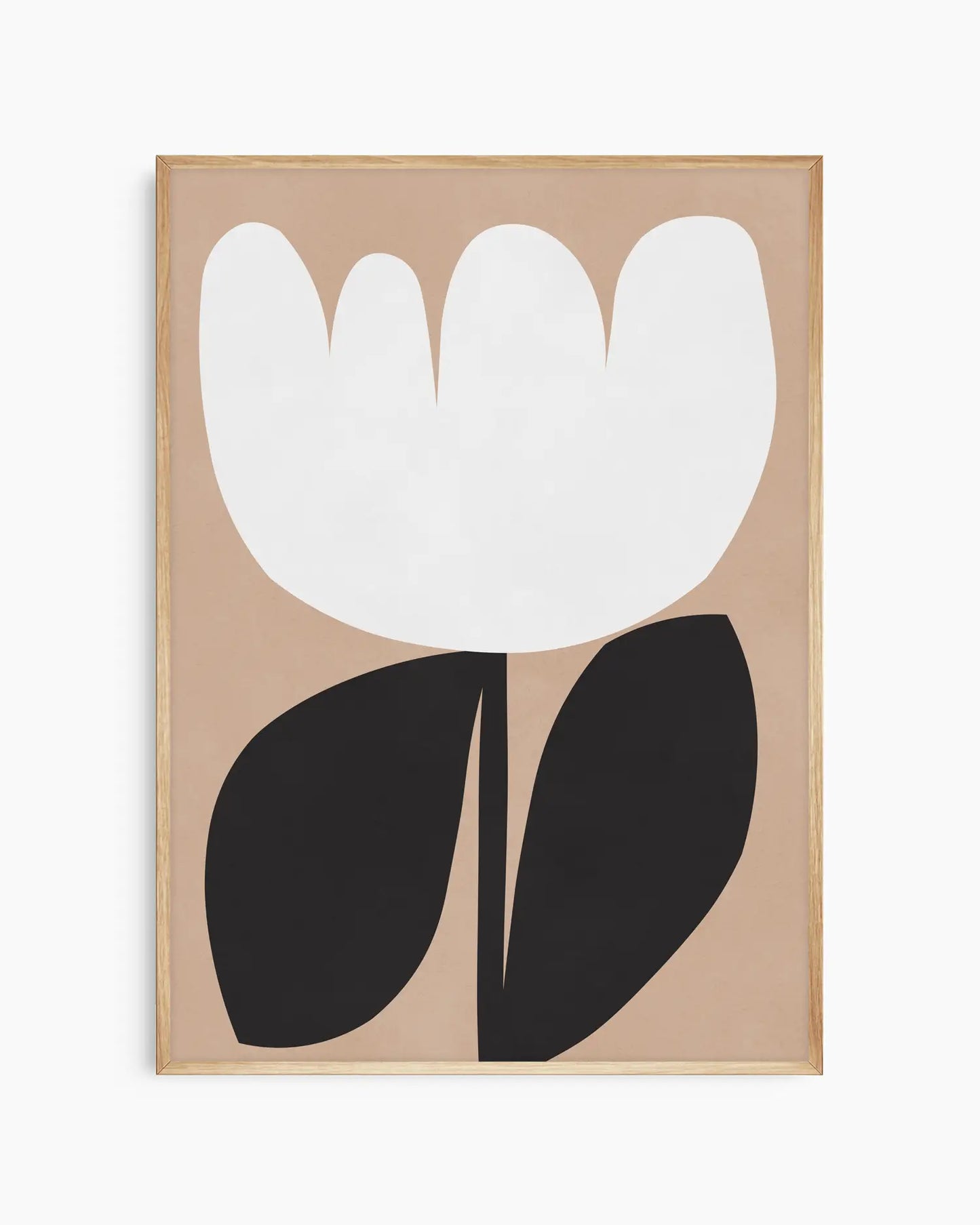 Framed artwork of a white flower with black leaves on a beige background
