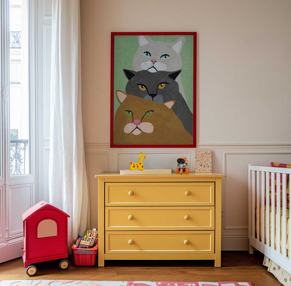 Whimsical cat wall art for kids, featuring three colorful cats with bright eyes and minimalist shapes. Framed and hanging above a yellow dresser in a cheerful children’s room – a fun and creative addition to modern nursery or playroom decor.