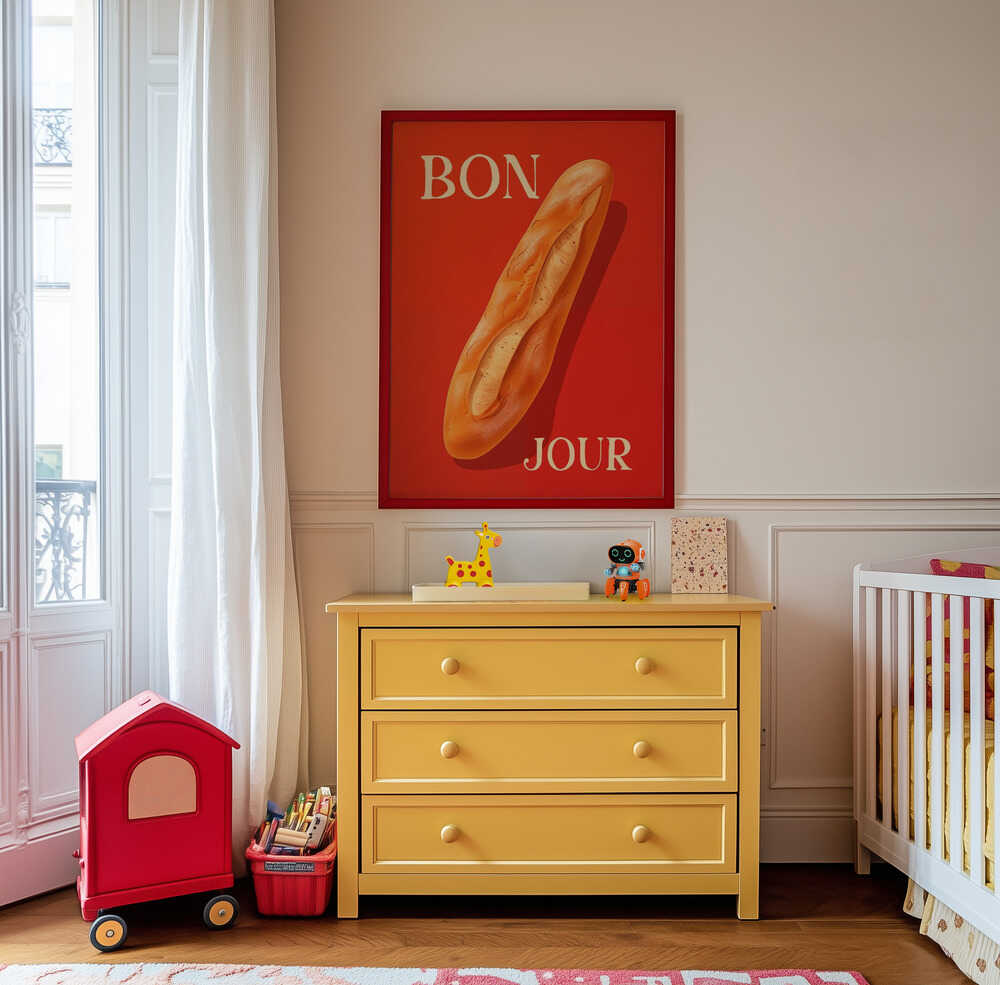 Framed poster with a baguette on a red background and the text 'BONJOUR' written on it hanging on a white wall in the nursery.