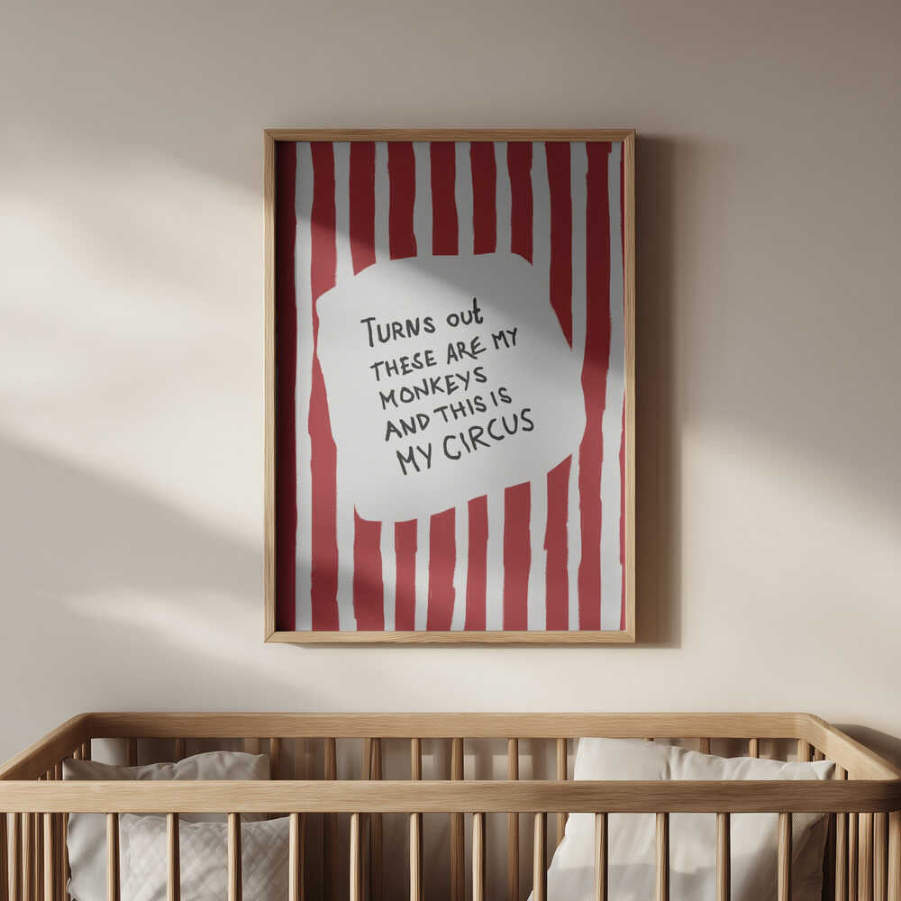 Nursery poster with the text 'Turns out these are my monkeys and this is my circus' on a red and white striped background hanging on the wall above the baby crib.