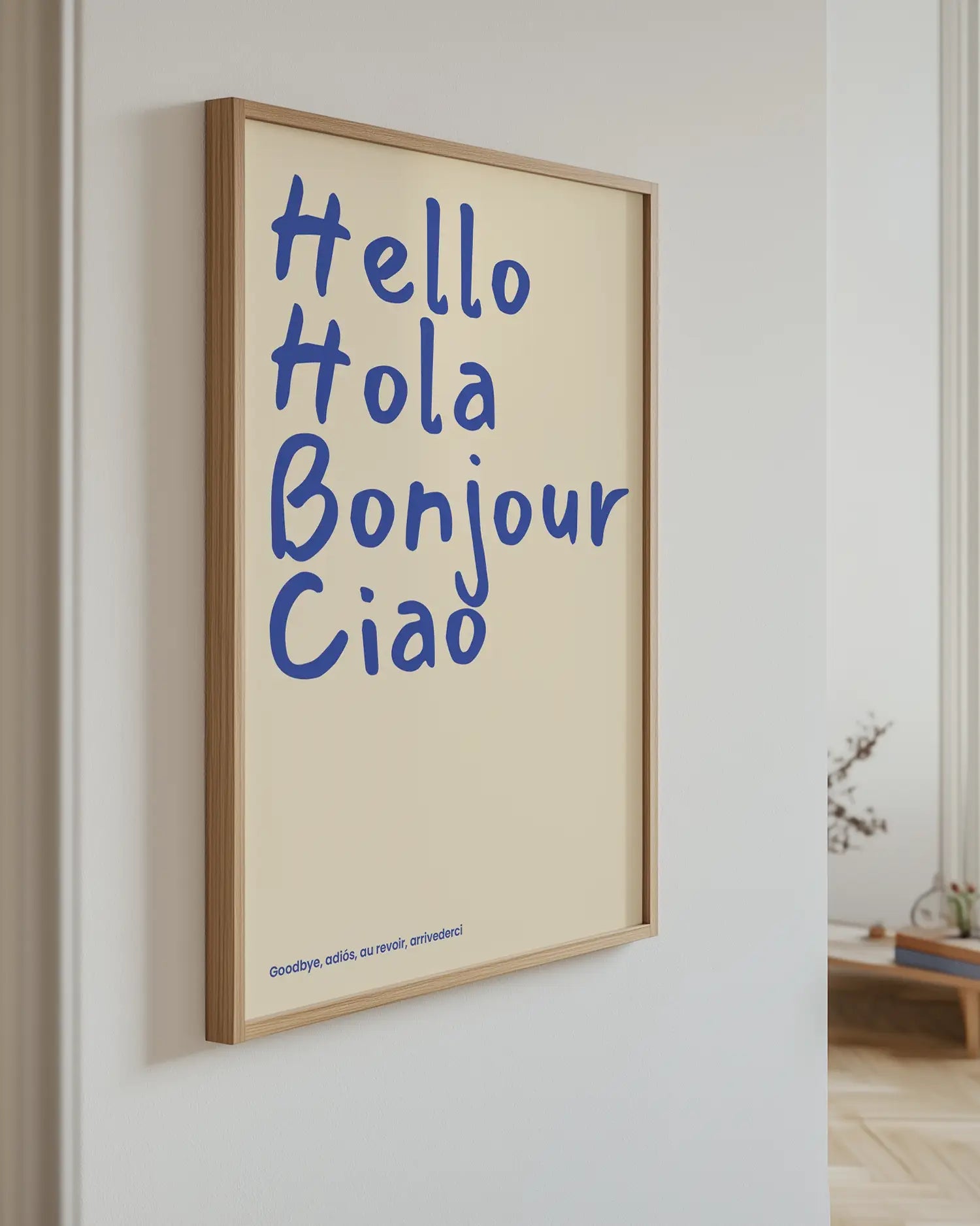 Framed artwork with 'Hello Hola Bonjour Ciao' text on a wall.