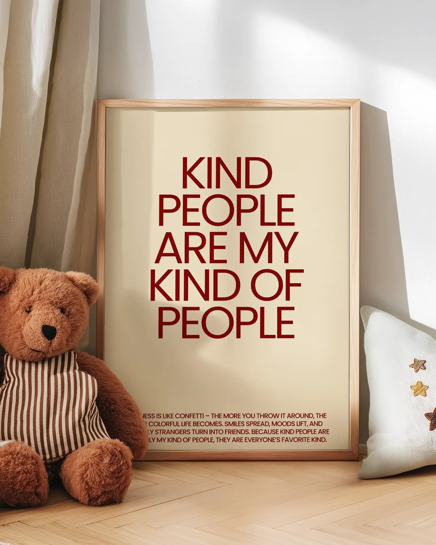 Framed quote 'Kind people are my kind of people' with a teddy bear on a wooden floor.