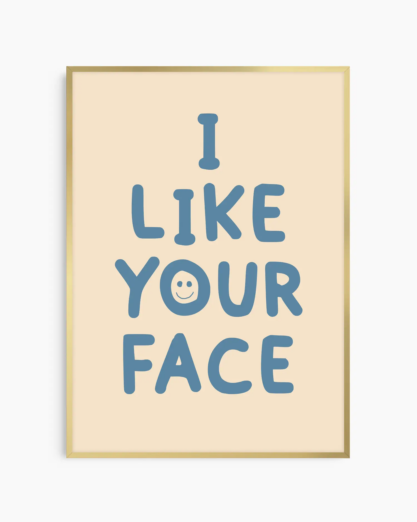 Beige nursery poster with the text 'I like your face' written in blue, framed in a gold frame.