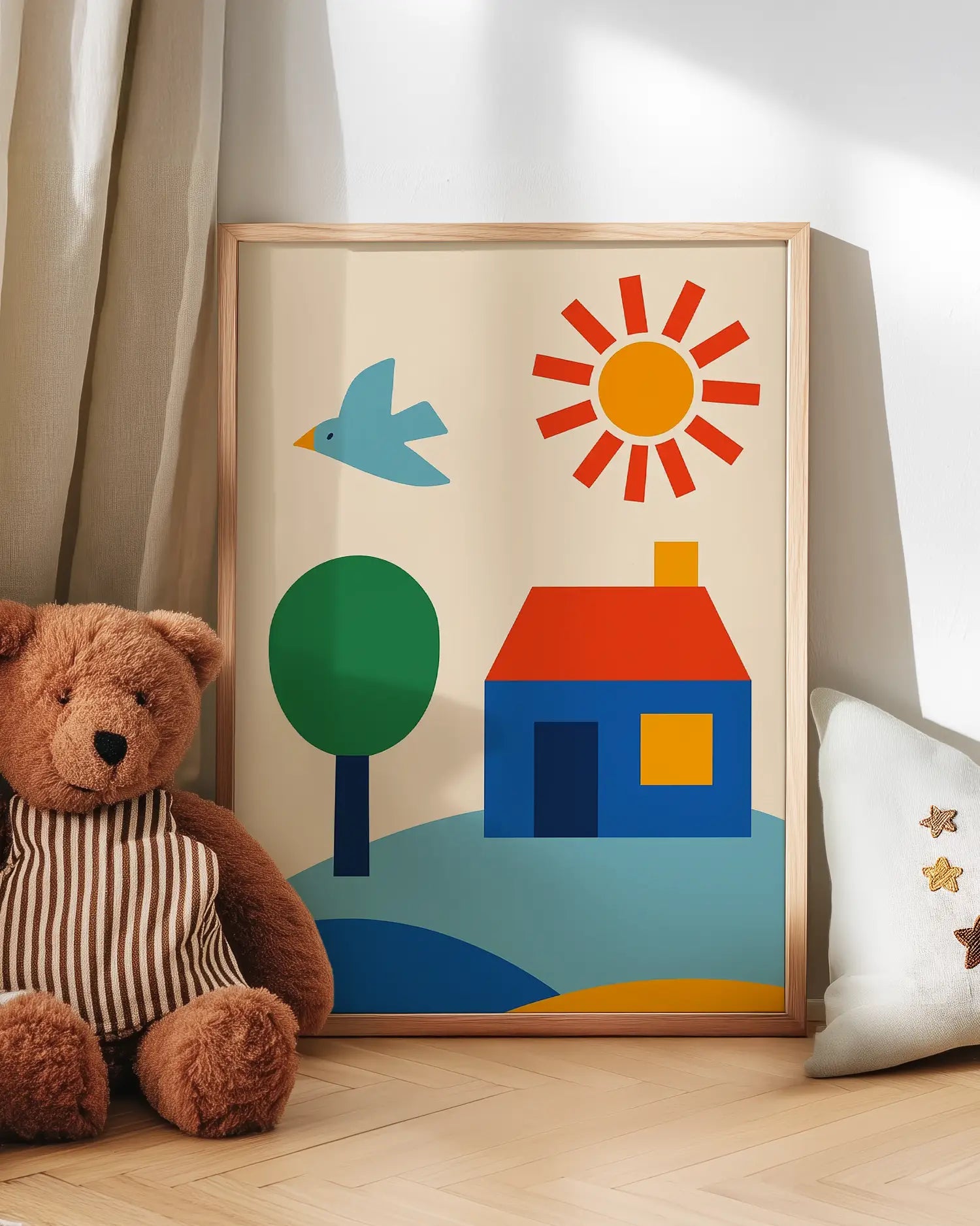 Children's art with a house, sun, and tree next to a teddy bear on a wooden floor.