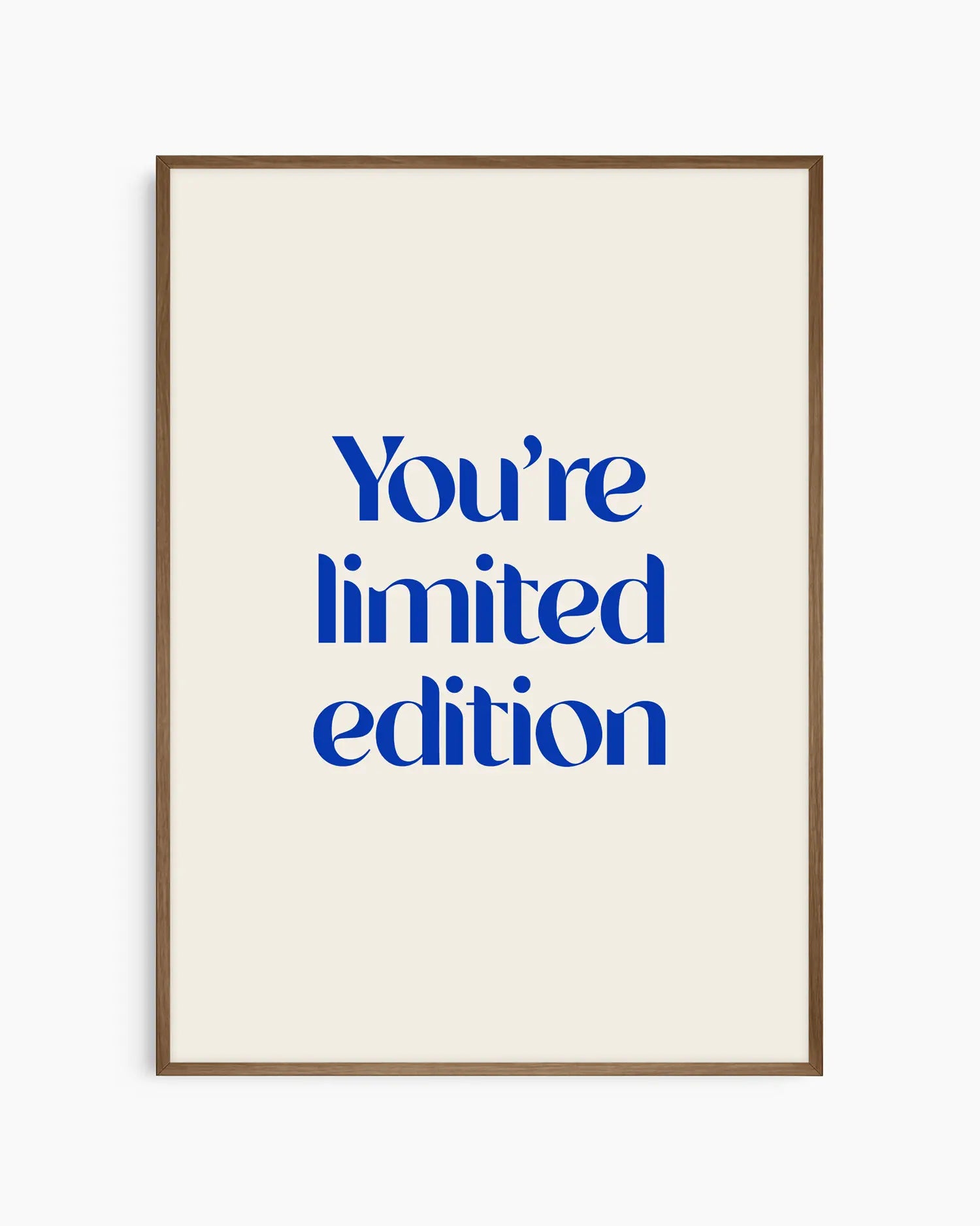 Nursery poster with 'You're limited edition' text in blue framed in a dark oak frame