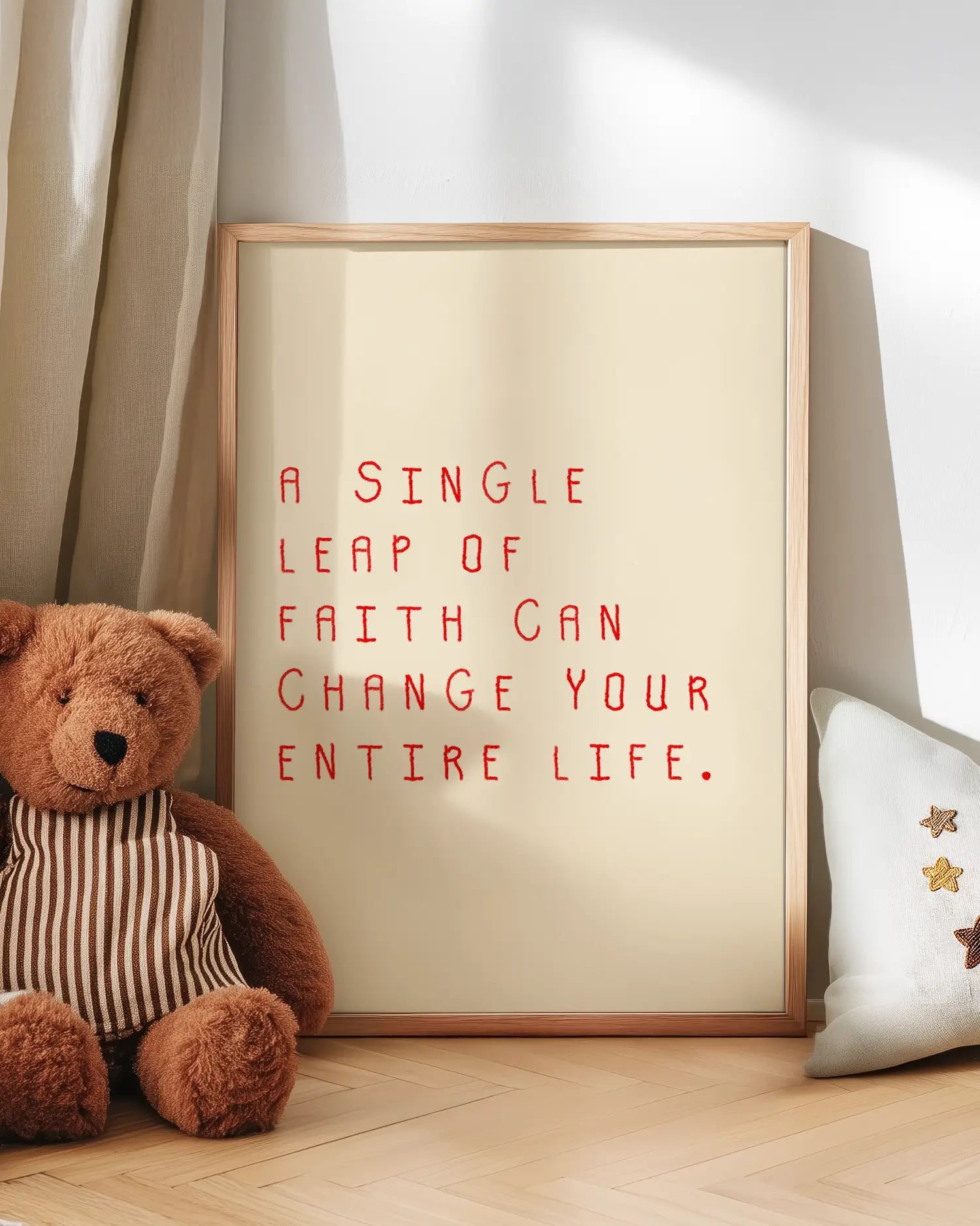 Wallart with motivational quote with teddy bear and pillow on wooden floor