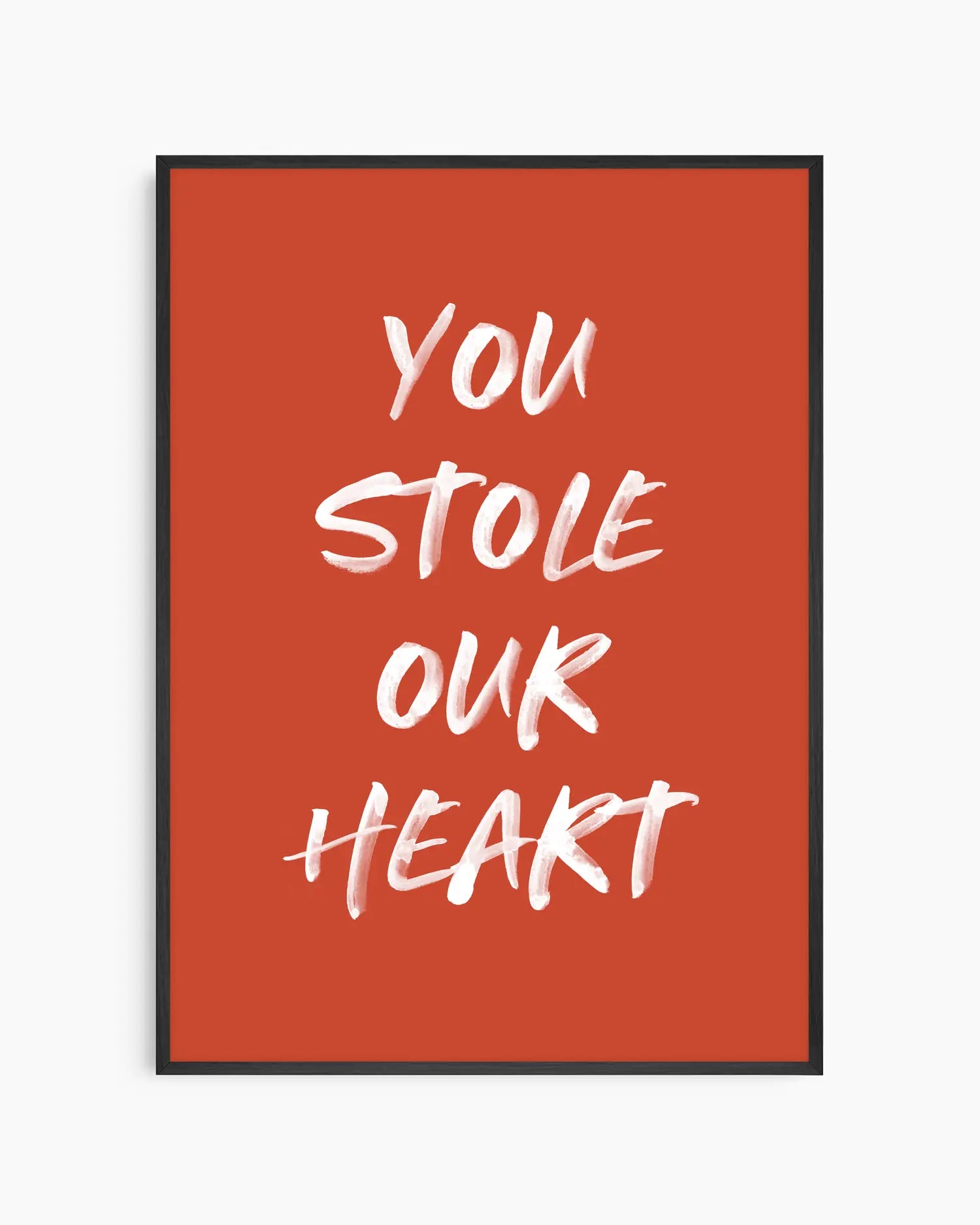 Nursery poster with white text 'You stole our heart' on a red background. Black frame.