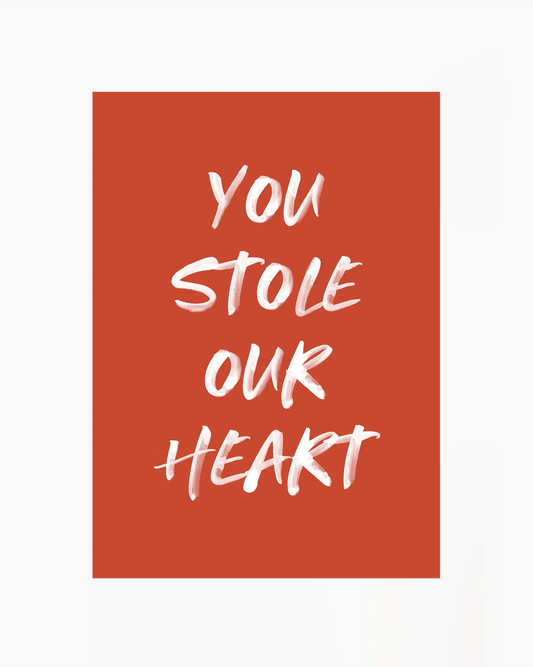 Nursery poster with white text 'You stole our heart' on a red background.