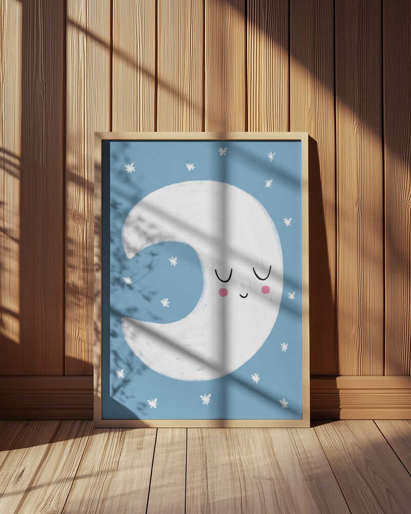 Framed Blue Moon poster featuring a smiling crescent moon with rosy cheeks on a soft blue background, surrounded by small white stars and lit by warm sunlight against wooden panels.