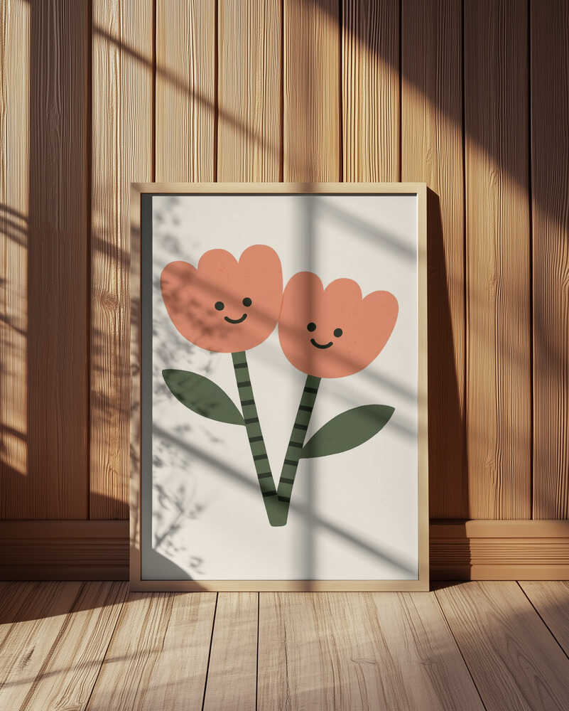 Framed poster with two happy flowers on a white background. Leaning against a wooden wall.