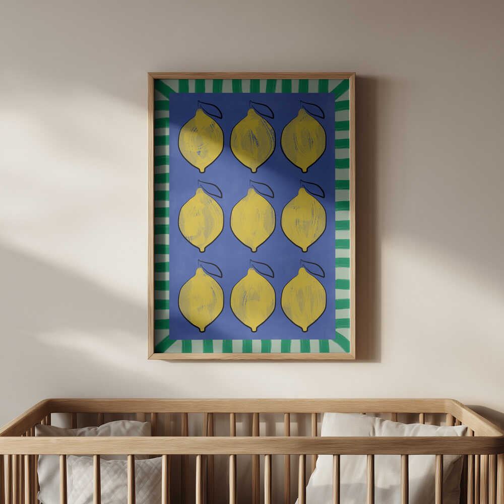 Poster of lemons on a blue background and a green striped frame around it hanging on the wall above the baby's crib